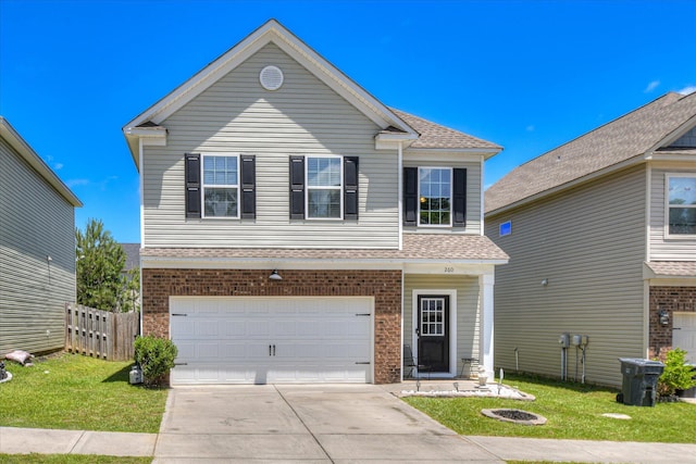 260 Claudia Dr, Grovetown, GA 30813 - traditional-style house with a garage, driveway, roof with shingles, and brick siding