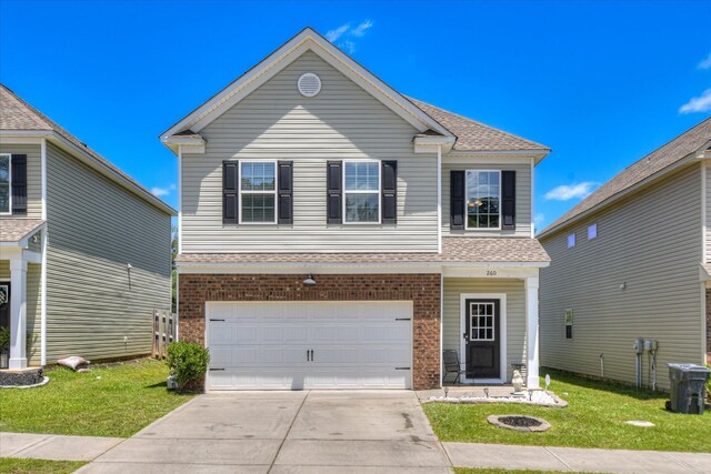 260 Claudia Dr, Grovetown, GA 30813 - view of front of property with an attached garage, driveway, a front lawn, a shingled roof, and brick siding