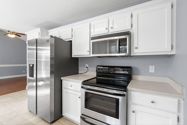 kitchen featuring light countertops, appliances with stainless steel finishes, ceiling fan, and white cabinets