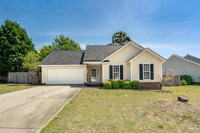 single story home with a front lawn, fence, roof with shingles, an attached garage, and driveway