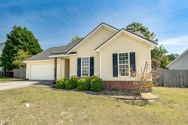 ranch-style home with fence, roof with shingles, a garage, a front yard, and driveway