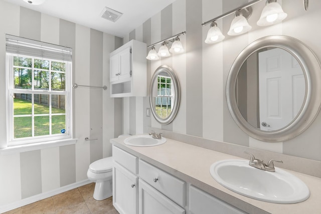 bathroom with a sink, tile patterned flooring, toilet, and visible vents