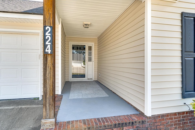 view of exterior entry featuring an attached garage