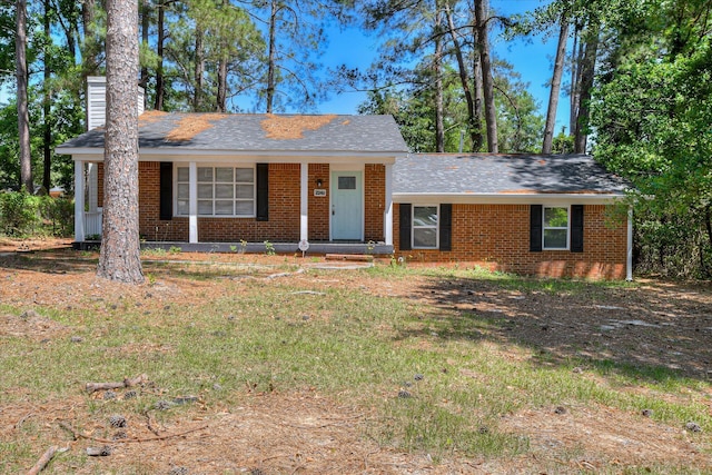 2249 Winston Way, Augusta, GA 30906 - view of front of home featuring brick siding, a chimney, covered porch, and roof with shingles