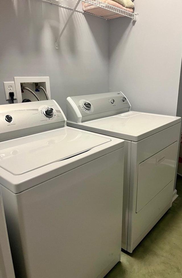 washroom featuring laundry area and separate washer and dryer