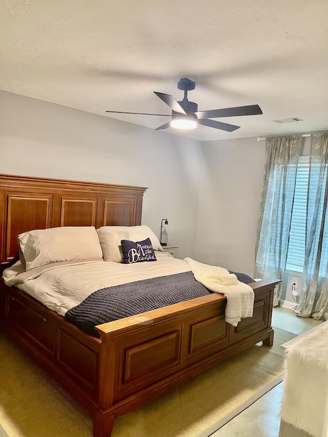 bedroom featuring a ceiling fan and visible vents