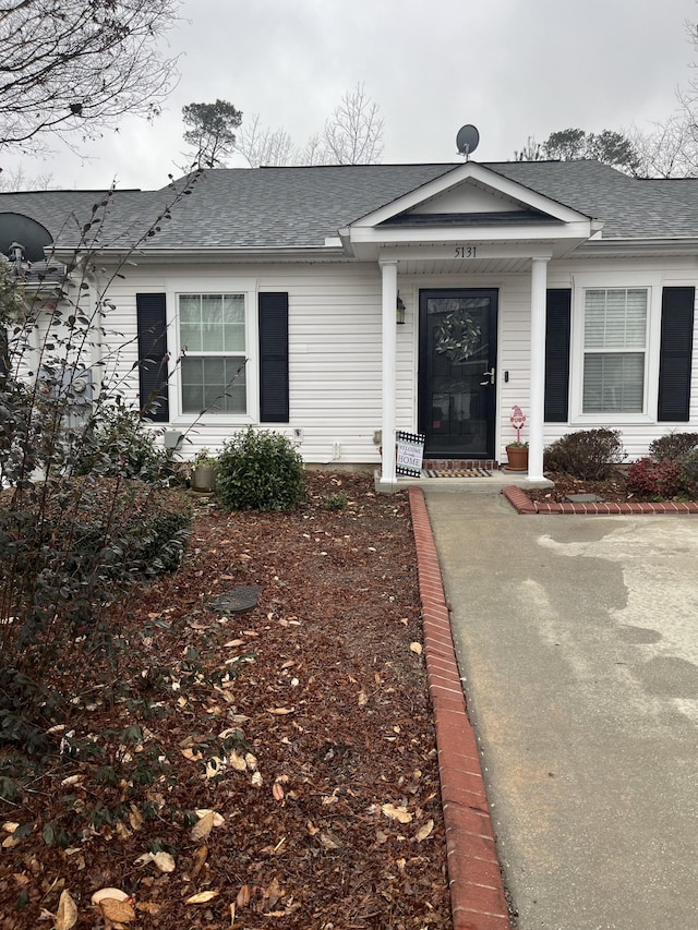 property entrance with a shingled roof