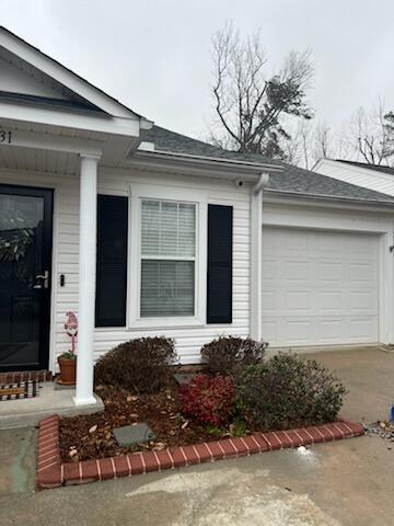 entrance to property with a garage and concrete driveway