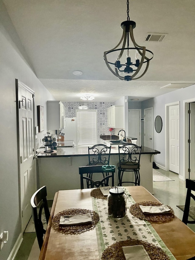 dining room with baseboards and visible vents