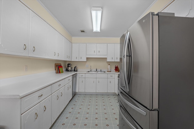 kitchen with light floors, visible vents, a sink, white cabinets, and appliances with stainless steel finishes