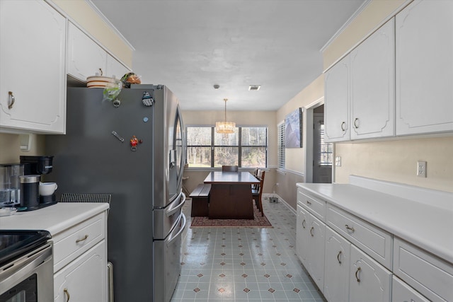 kitchen with a notable chandelier, light countertops, and white cabinetry