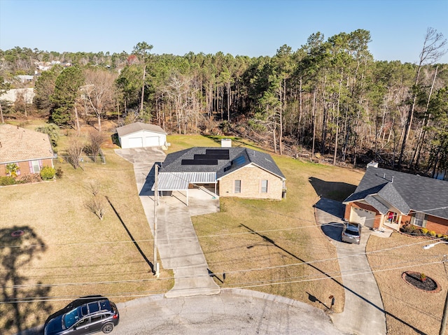 birds eye view of property featuring a wooded view