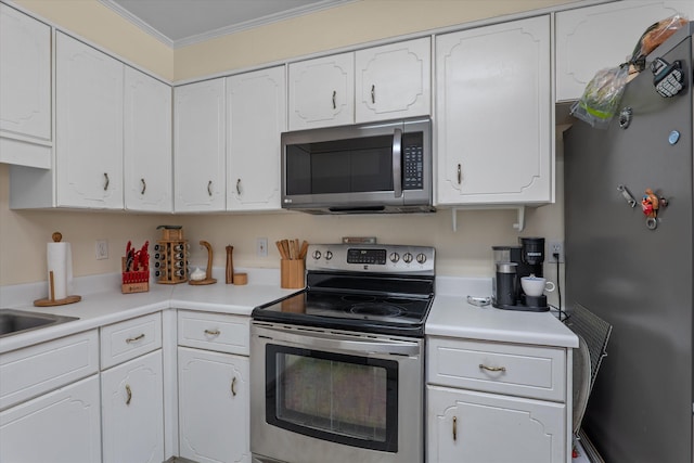 kitchen featuring white cabinetry, light countertops, appliances with stainless steel finishes, and ornamental molding