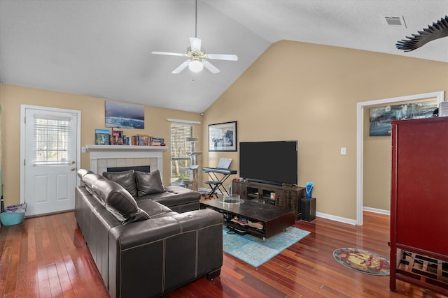 living area with visible vents, baseboards, ceiling fan, and hardwood / wood-style flooring