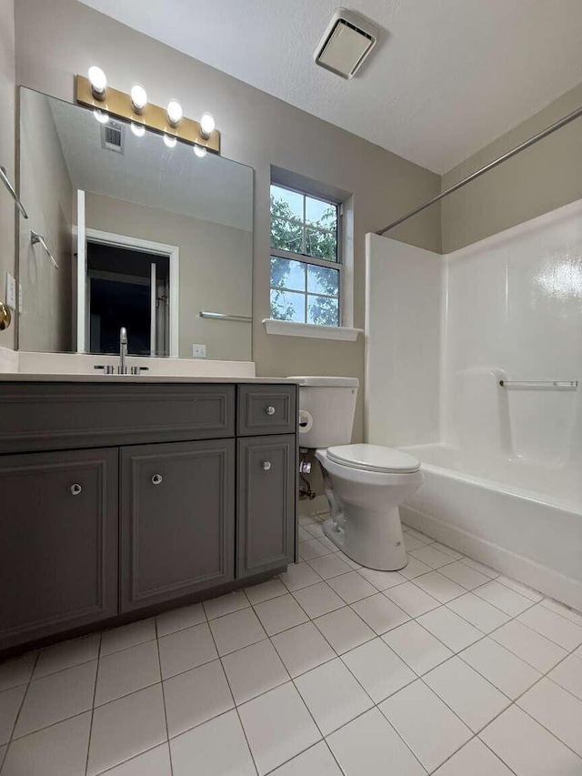 full bathroom with toilet, vanity, tile patterned flooring, and shower / washtub combination
