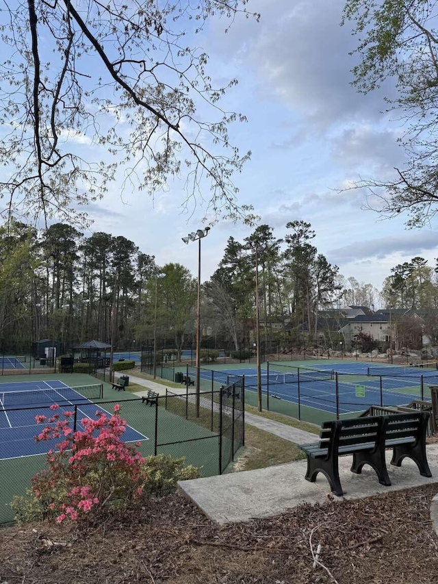 view of tennis court featuring fence