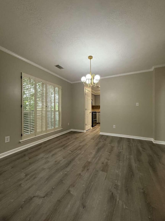 unfurnished dining area featuring a chandelier, dark wood-style floors, baseboards, a textured ceiling, and crown molding