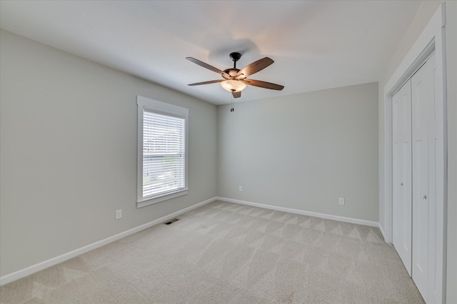 997 Glenhaven Dr, Evans, GA 30809 - unfurnished bedroom with light carpet, a closet, and a ceiling fan