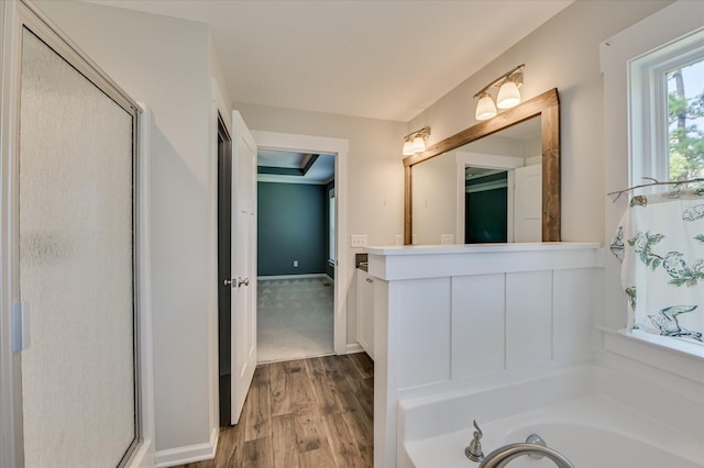 997 Glenhaven Dr, Evans, GA 30809 - full bathroom featuring wood finished floors, a stall shower, a bath, and vanity