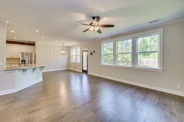 997 Glenhaven Dr, Evans, GA 30809 - unfurnished living room featuring ornamental molding, a ceiling fan, recessed lighting, and dark wood-style flooring