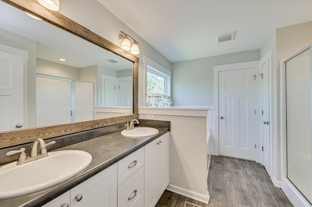 997 Glenhaven Dr, Evans, GA 30809 - bathroom with a stall shower, wood finished floors, and double vanity
