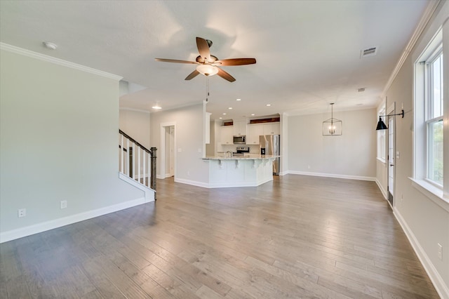 997 Glenhaven Dr, Evans, GA 30809 - unfurnished living room featuring ceiling fan, stairs, wood-type flooring, ornamental molding, and recessed lighting