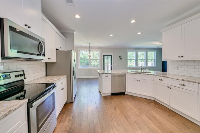 997 Glenhaven Dr, Evans, GA 30809 - kitchen with appliances with stainless steel finishes, recessed lighting, white cabinetry, a peninsula, and light wood-style floors