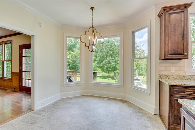 3549 Stevens Way, Martinez, GA 30907 - unfurnished dining area featuring plenty of natural light, a chandelier, crown molding, and light stone finish flooring