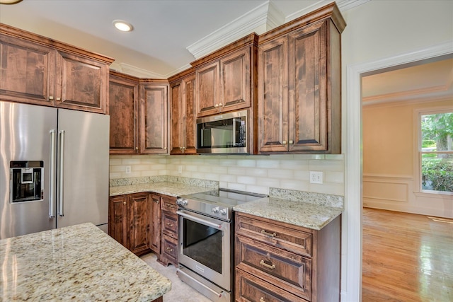 3549 Stevens Way, Martinez, GA 30907 - kitchen featuring appliances with stainless steel finishes, ornamental molding, light stone countertops, light wood-style flooring, and backsplash