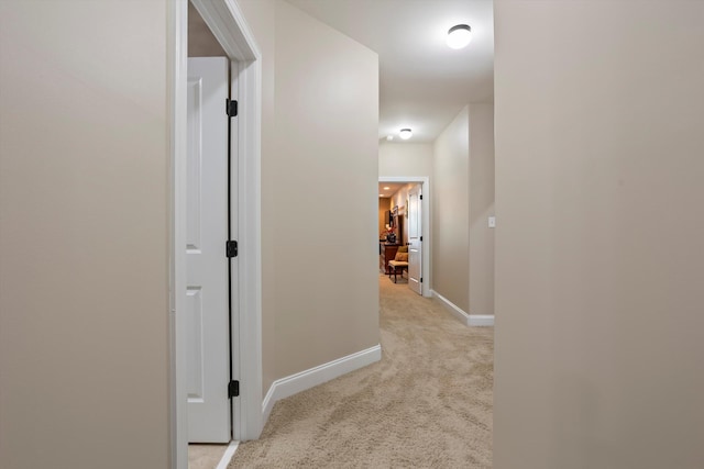 corridor featuring light colored carpet