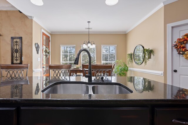 kitchen with hanging light fixtures, plenty of natural light, a notable chandelier, and sink