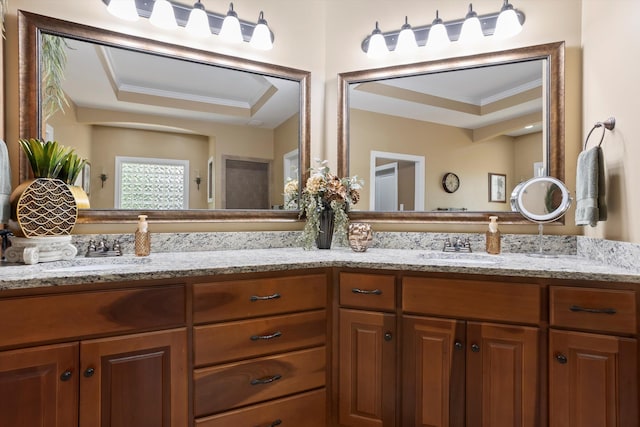 bathroom with vanity, a raised ceiling, and crown molding