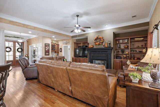 living room featuring ceiling fan, light hardwood / wood-style flooring, french doors, and ornamental molding