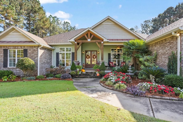 view of front facade featuring french doors and a front lawn