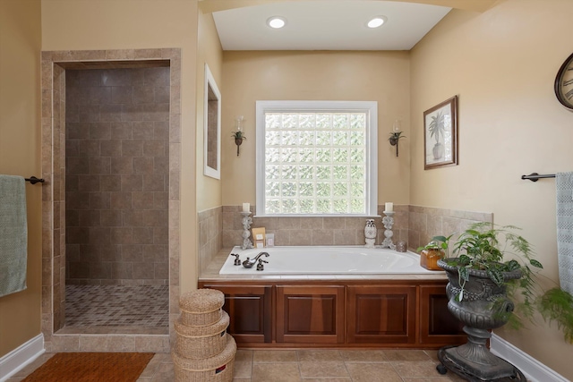 bathroom featuring tile patterned floors and independent shower and bath