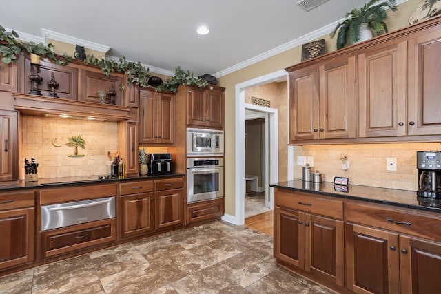 kitchen with backsplash, stainless steel appliances, dark stone counters, and crown molding