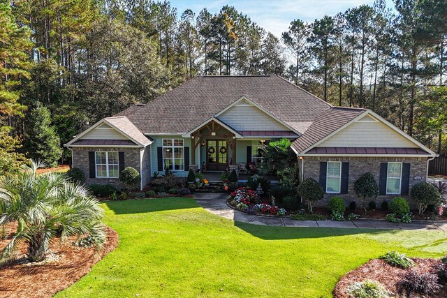 craftsman-style home featuring a porch and a front lawn