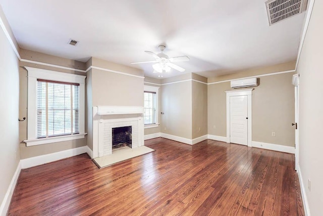 116 Jackson Rd, Jackson, SC 29831 - unfurnished living room featuring a wall mounted AC, ceiling fan, wood finished floors, a fireplace, and baseboards