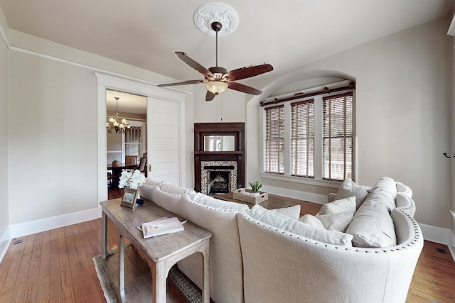 116 Jackson Rd, Jackson, SC 29831 - living room with a chandelier, a fireplace, wood-type flooring, baseboards, and ceiling fan