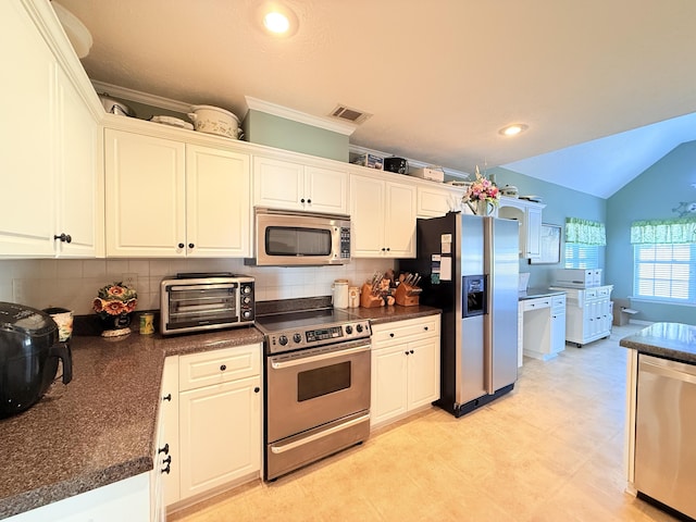 kitchen featuring tasteful backsplash, a toaster, visible vents, dark countertops, and stainless steel appliances