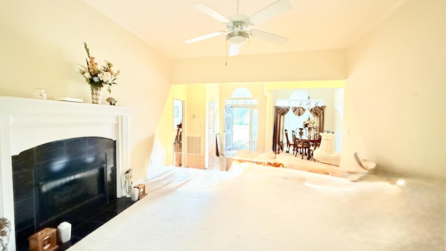 living area with a fireplace with flush hearth and ceiling fan