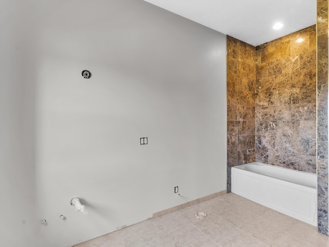 bathroom with tile patterned flooring and a bathtub