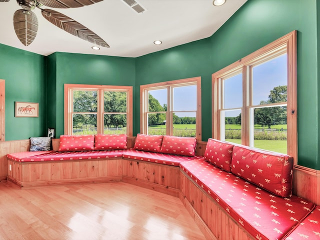 living area featuring a wealth of natural light and light hardwood / wood-style flooring