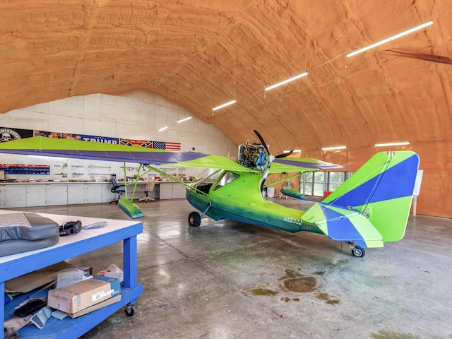 interior space with concrete floors and vaulted ceiling