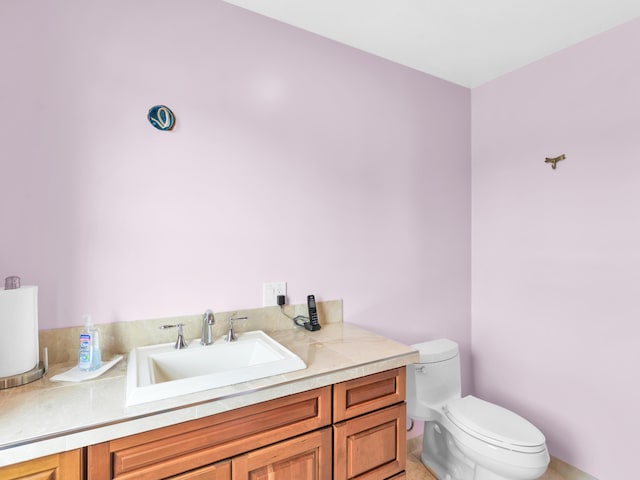 bathroom with tile patterned floors, vanity, and toilet