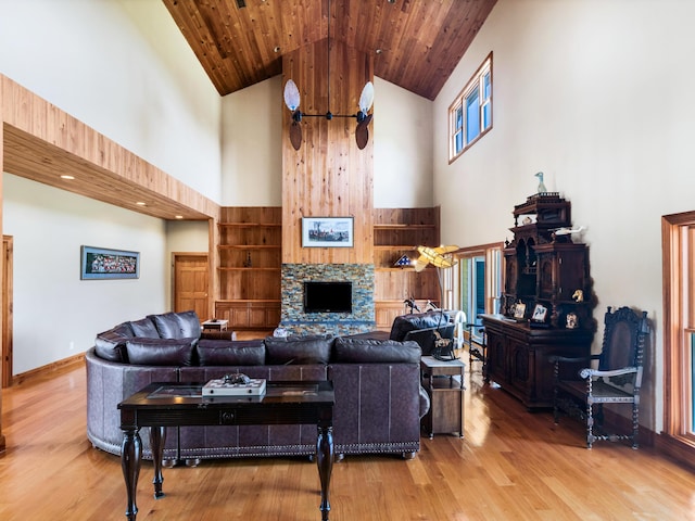 living room featuring a fireplace, hardwood / wood-style flooring, high vaulted ceiling, and wood ceiling