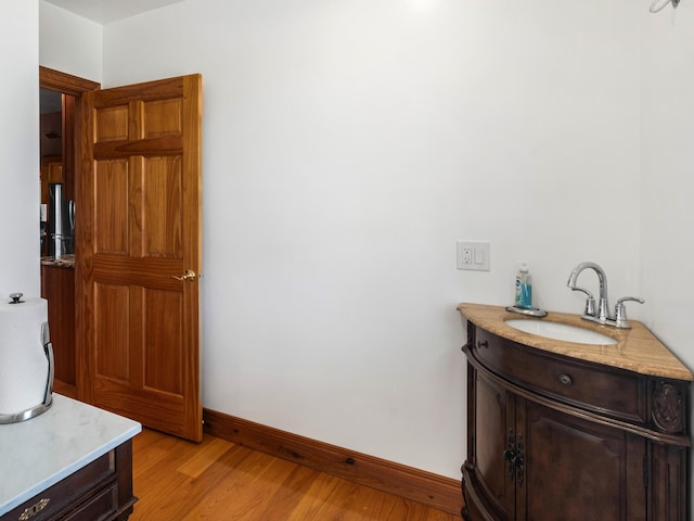 bathroom featuring hardwood / wood-style floors and vanity