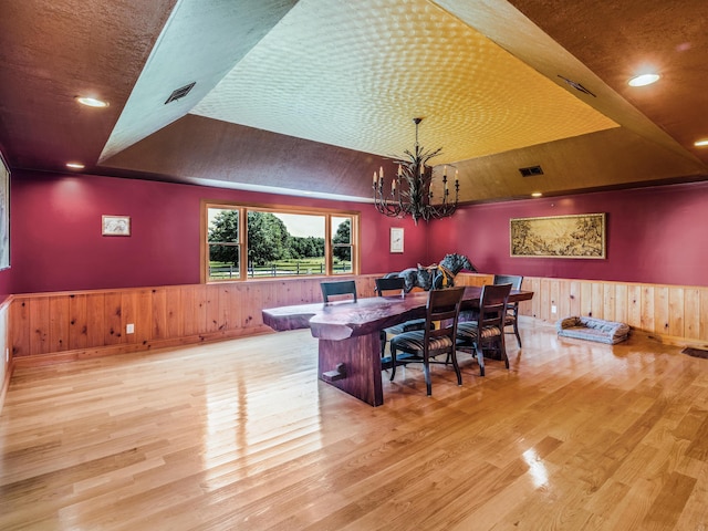 bar featuring an inviting chandelier, a raised ceiling, wood-type flooring, lofted ceiling, and wood ceiling