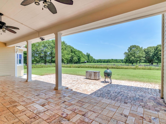 view of patio / terrace with grilling area, ceiling fan, and a rural view