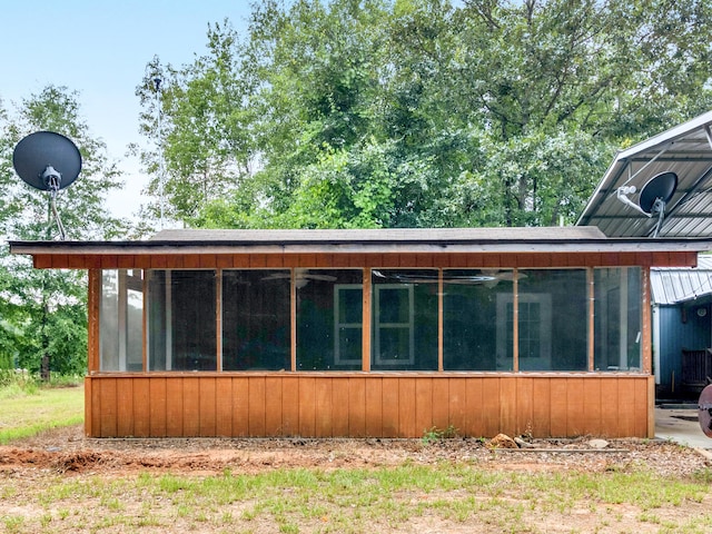 rear view of house featuring a sunroom